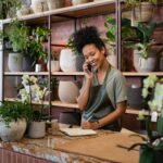 Florist takes an order on the phone at flower shop